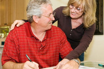Mature couple happy about paying off their debts.